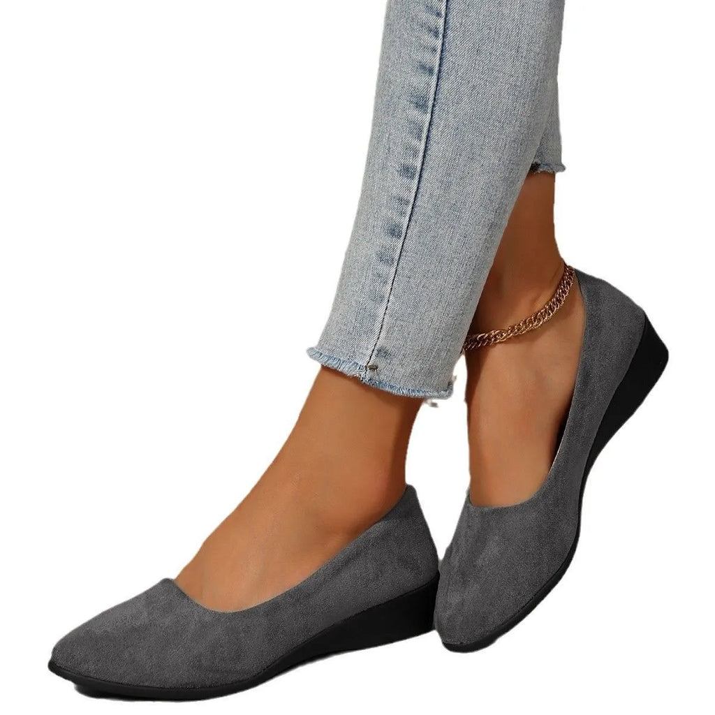 Women's black pointed toe wedge pumps with shallow mouth opening and low rubber wedge heel