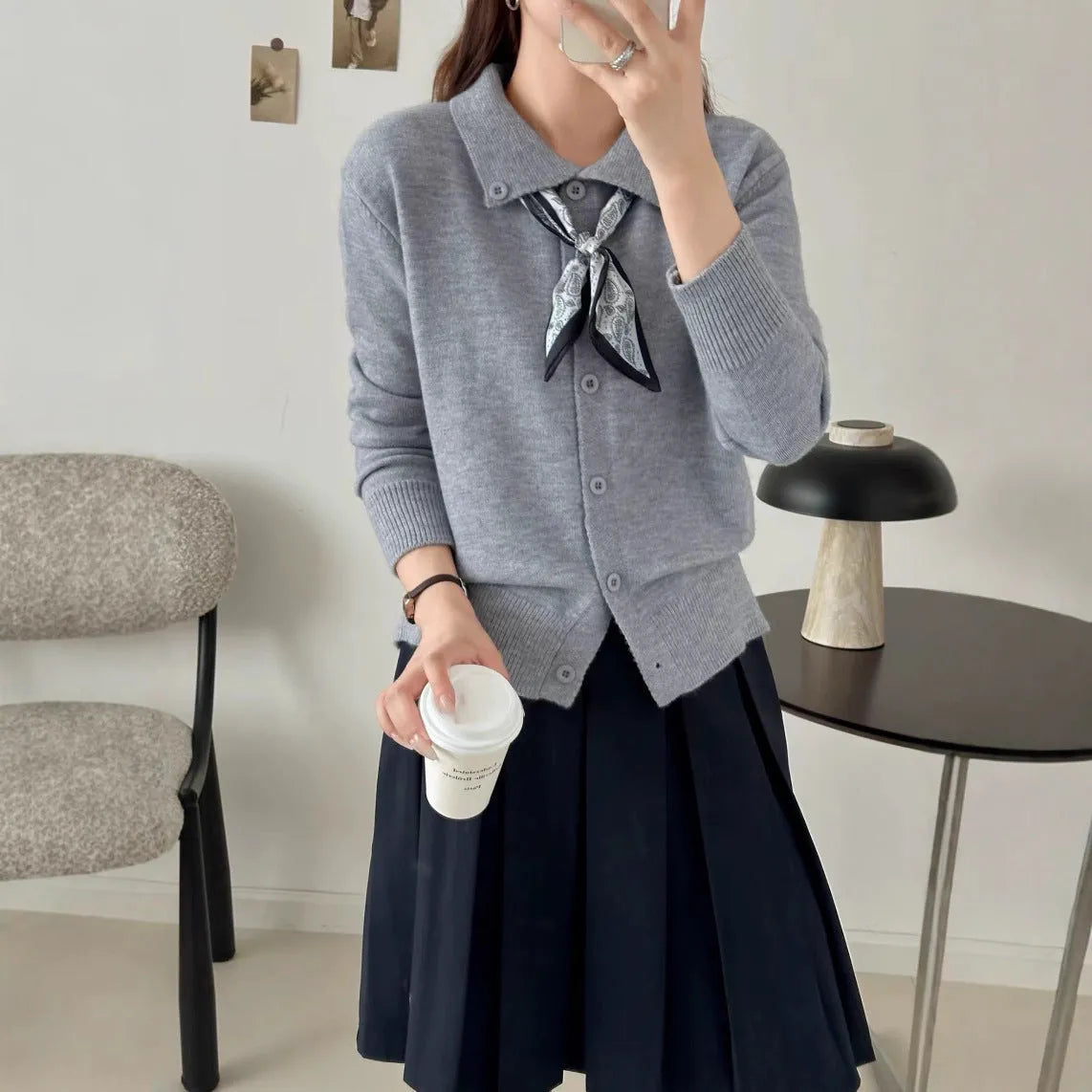 Beige lapel scarf collar cardigan sweater with long sleeves on a hanger