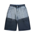 Loose fit blue tie-dye gradient cropped jeans on a hanger, showing washed-out colour and mid-waist design.