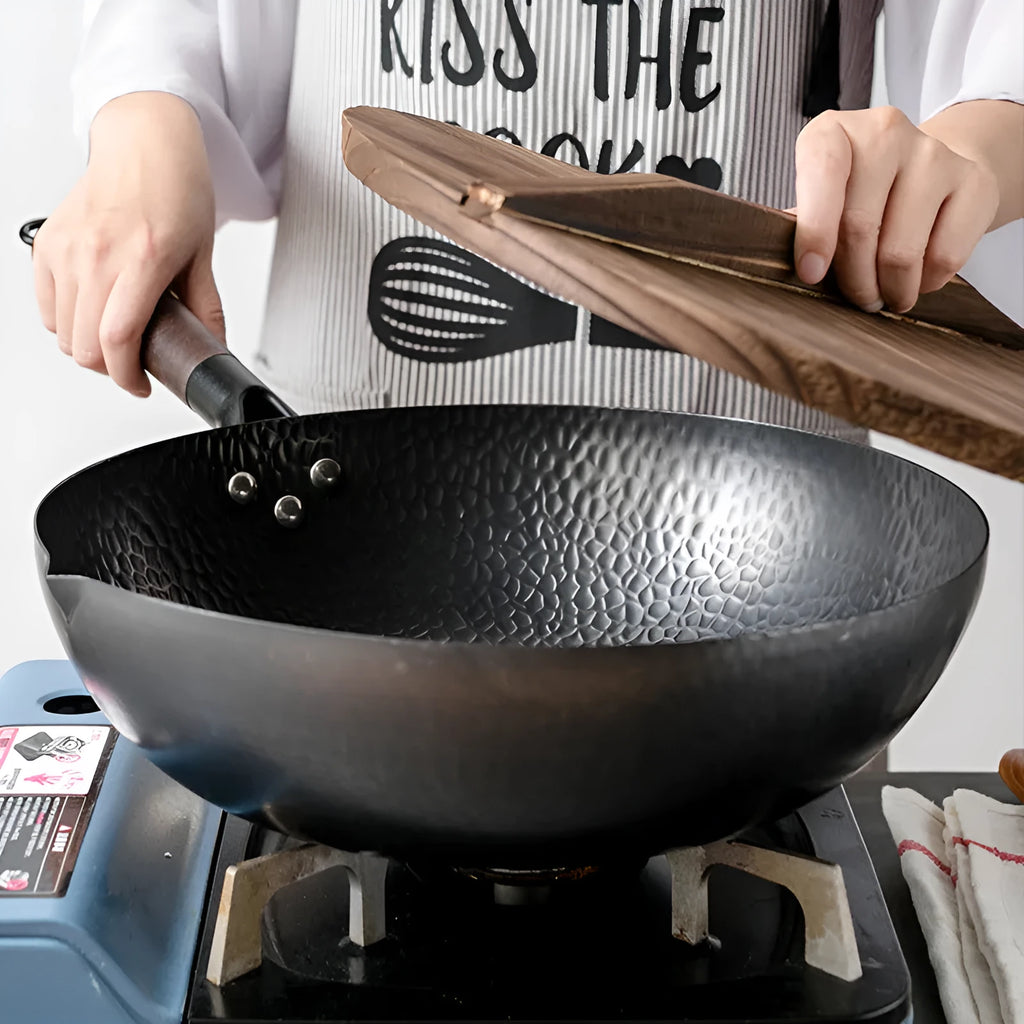 Traditional black iron wok with wooden handle measuring 32cm