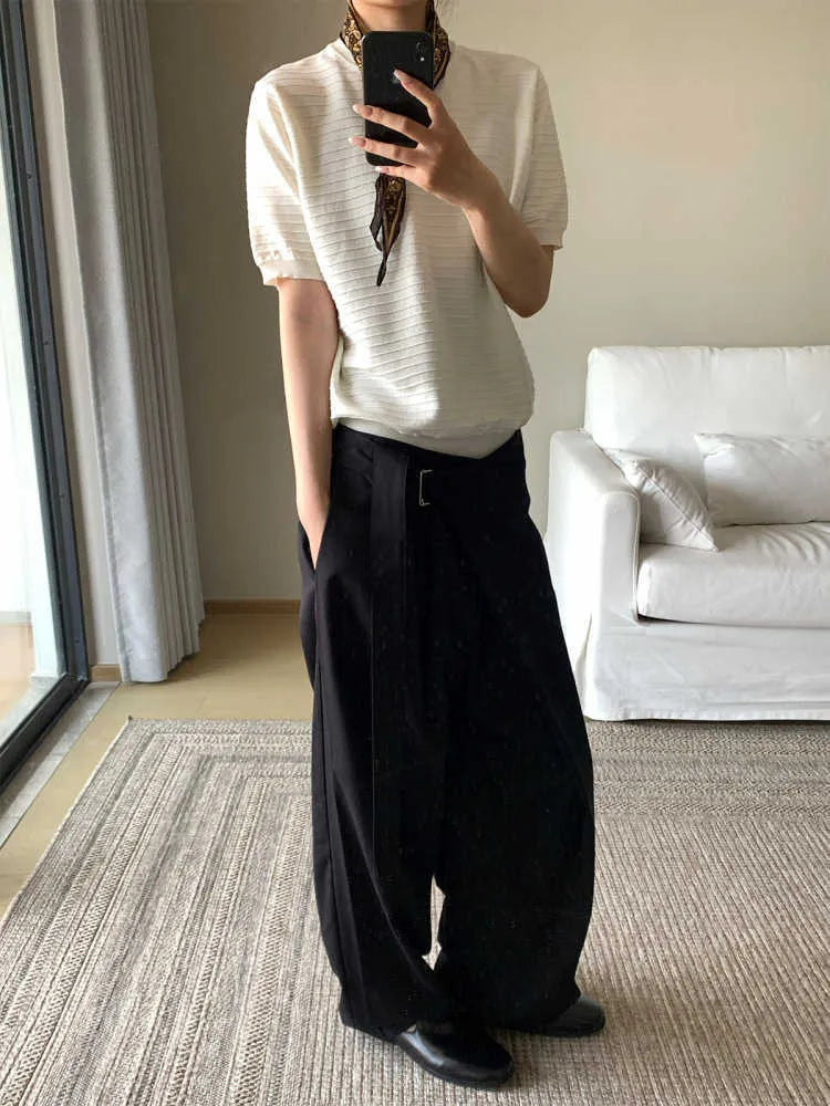 Black straight-leg trousers with a single pleat and adjustable waistband on a neutral background.