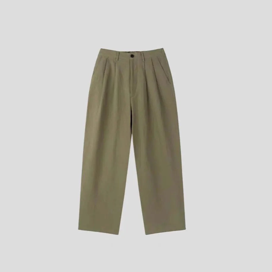 Men's loose-fit apricot cotton linen trousers with wide-leg Korean style on a neutral background.