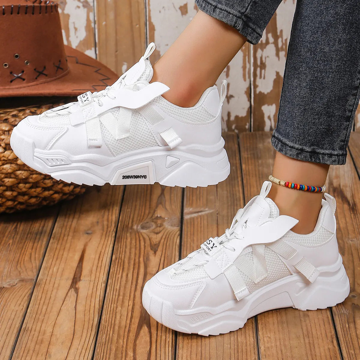 Women's purple and white platform mesh sports sneakers with front lace-up design on a plain background.