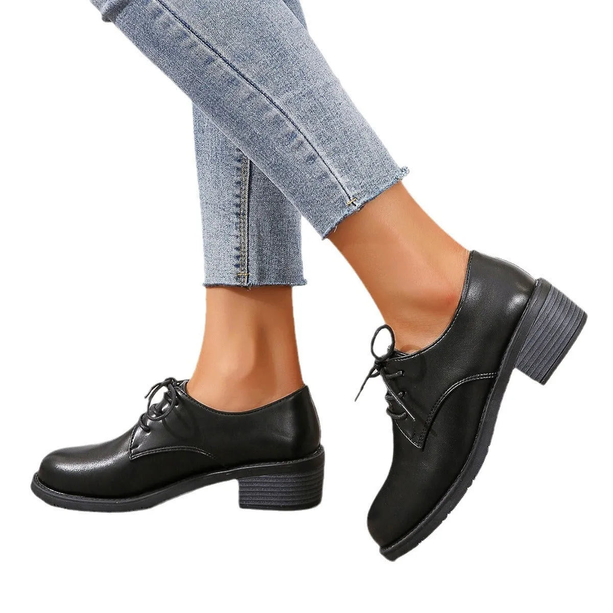 Black women's low-top work shoes with a chunky mid heel and soft rubber sole.