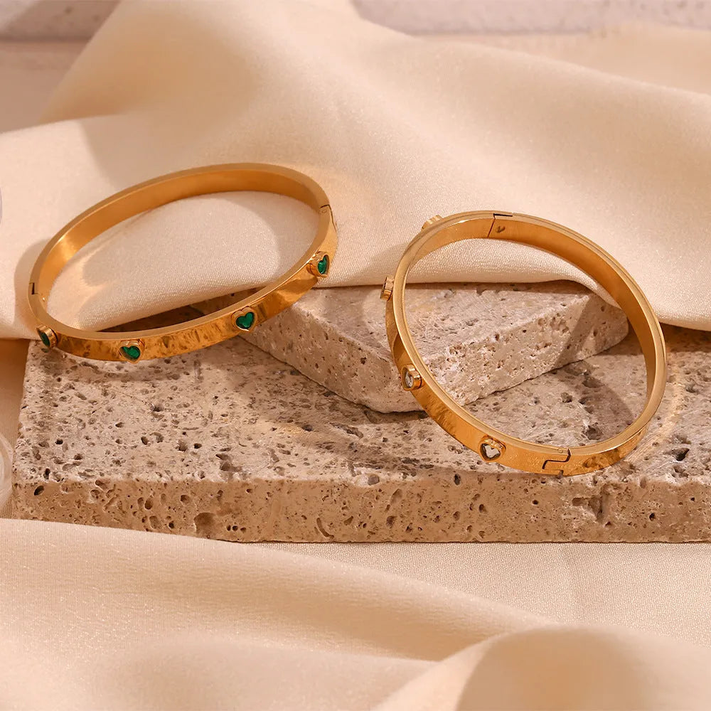 Stainless steel bracelet with a peach heart charm, shown in golden-lvzuan finish.