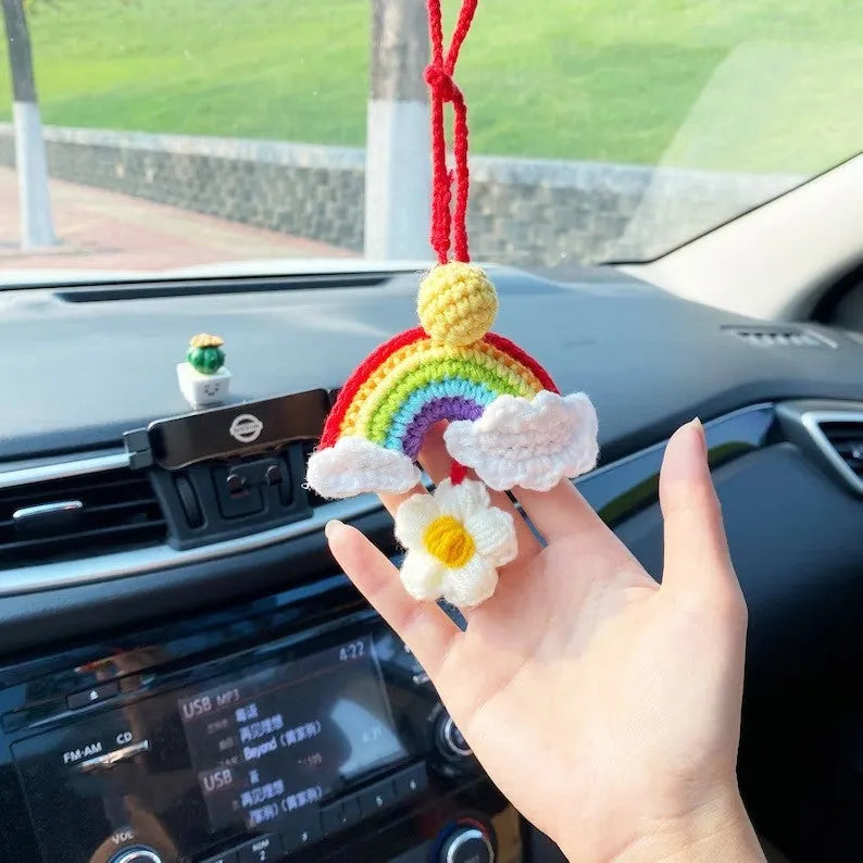 Handmade crocheted rainbow flower car pendant in wool yarn with avocado, pink, and red colour options