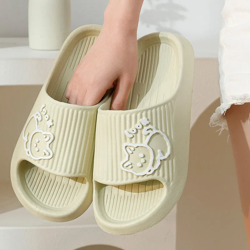 Women's green cat slippers with thick platform sole and flip-flop design.