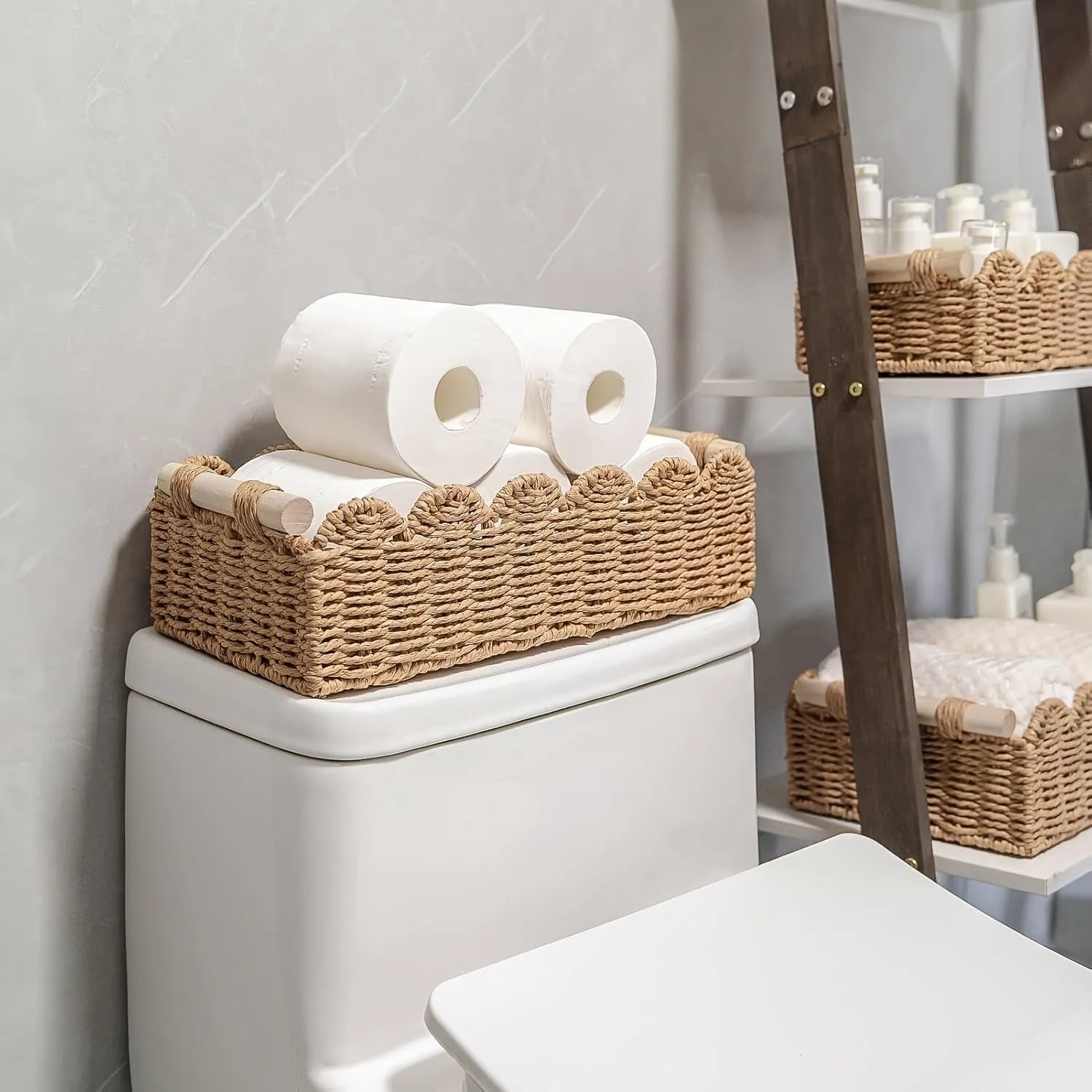 Modern woven rectangular storage basket in khaki colour on a wooden table holding remote controls and pens.