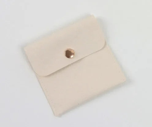 Beige brown cardboard drawer jewellery box with a storage bag beside it