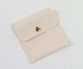 Beige brown cardboard drawer jewellery box with a storage bag beside it