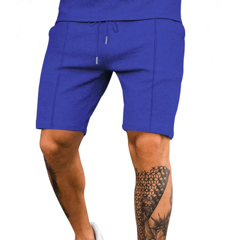 Solid colour polyester five-point sports shorts in Khaki, side view, showing elastic waist and above-knee length