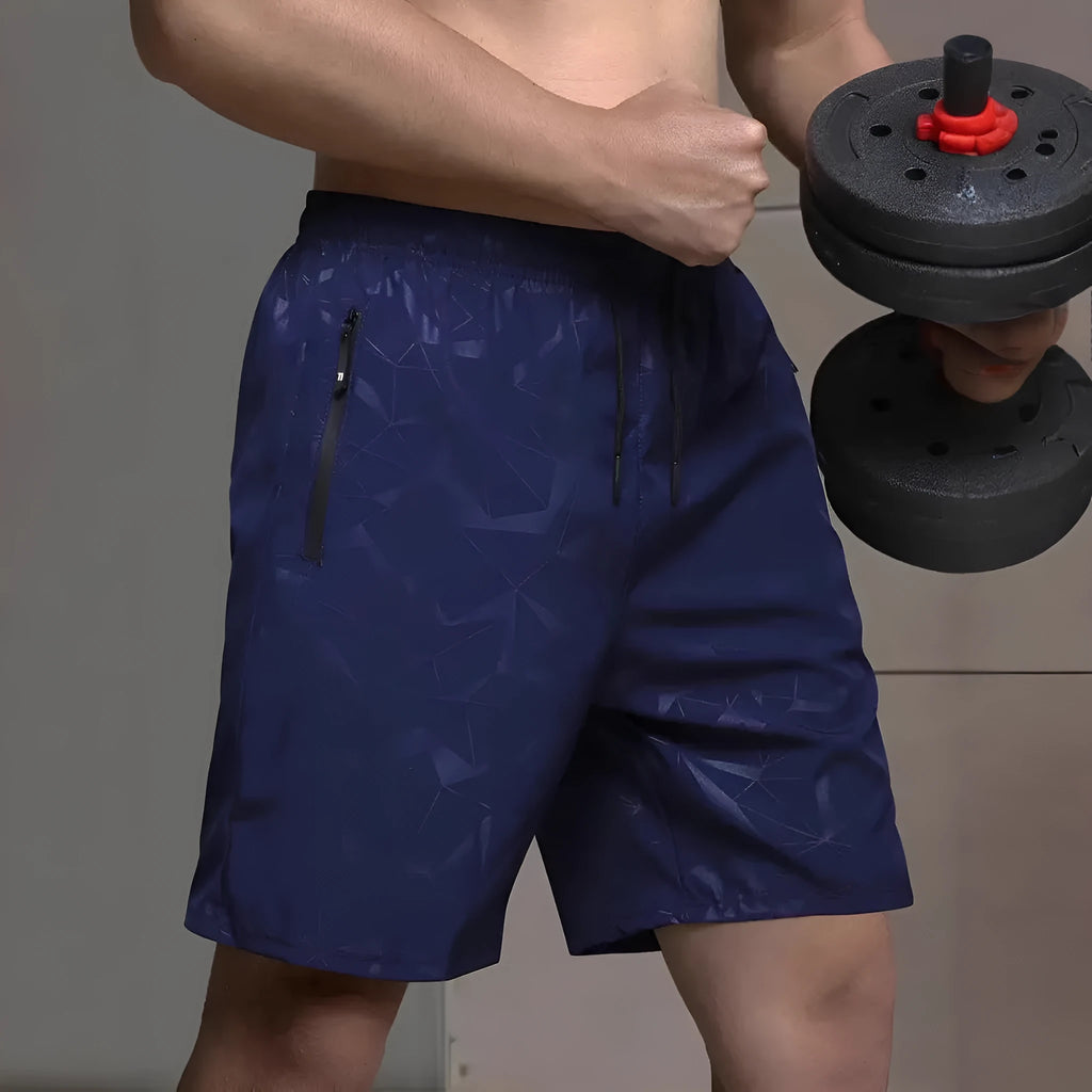 Man wearing loose black polyester sports shorts with an elastic waistband, suitable for gym or casual wear.