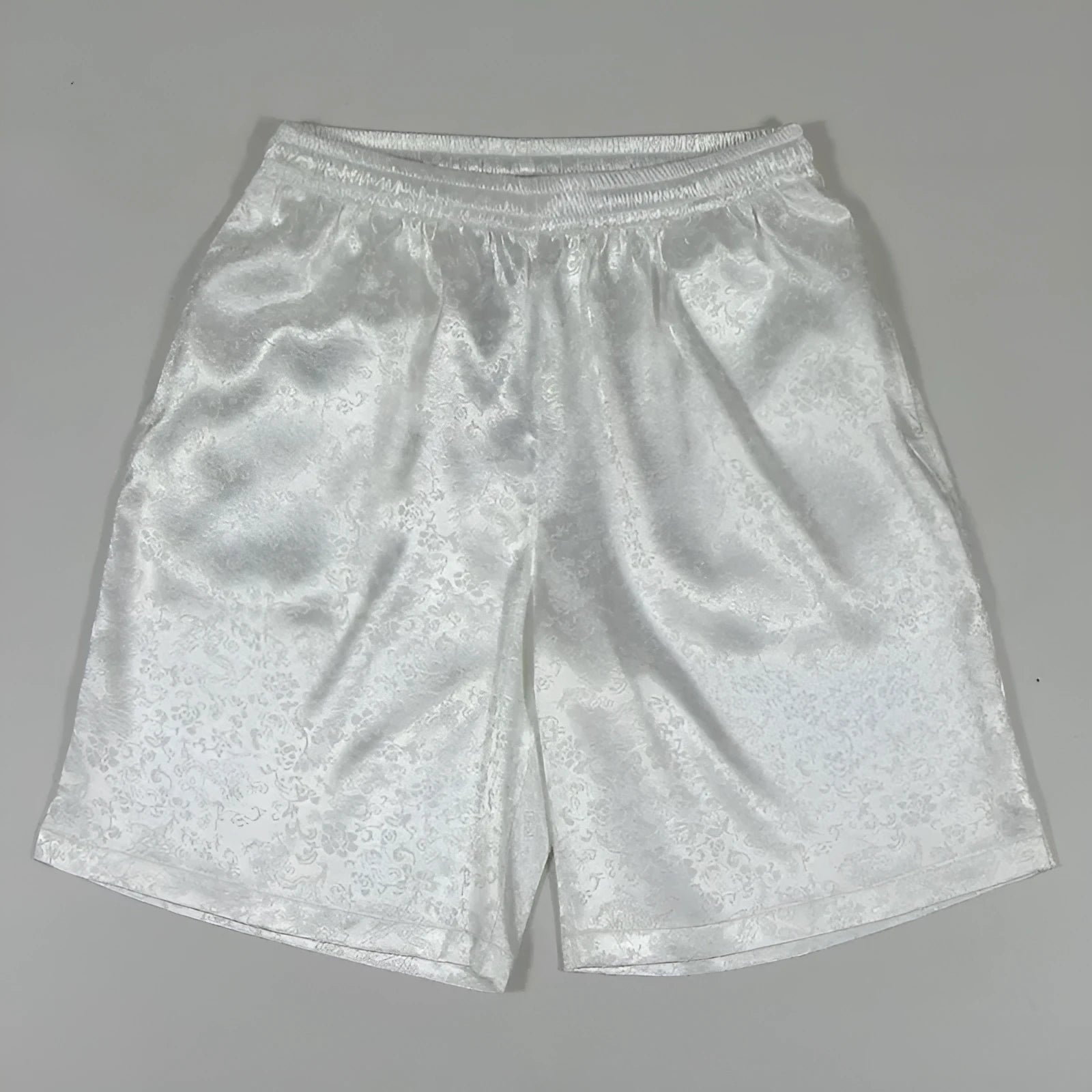 Man wearing traditional black Tang suit style shorts with an elastic drawstring waistband.
