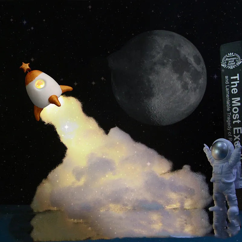 DIY astronaut rocket night light kit with warm LED string lights, plastic chassis, and straws for assembly.