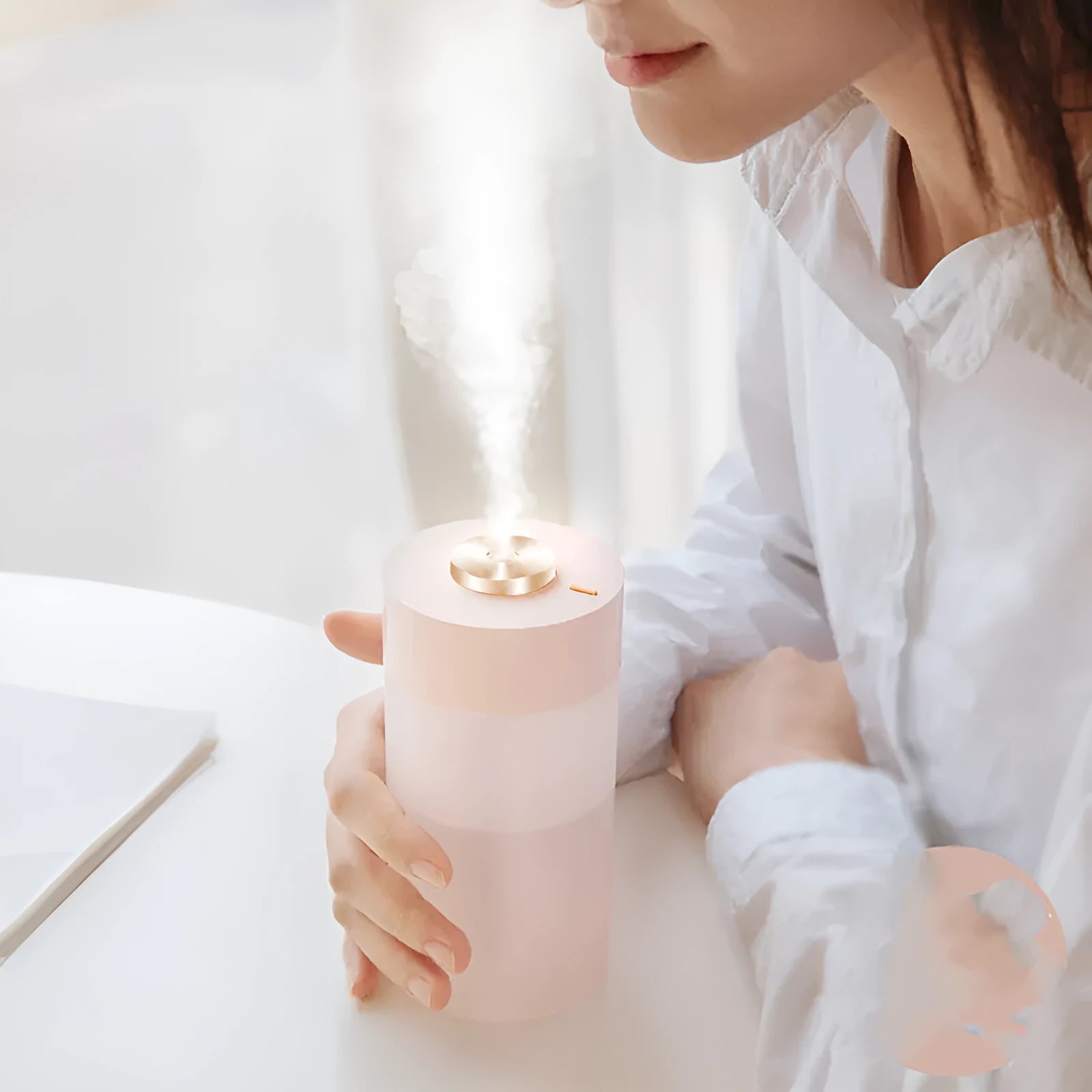 Columnar car USB humidifier in ice white with timer, placed in car cup holder