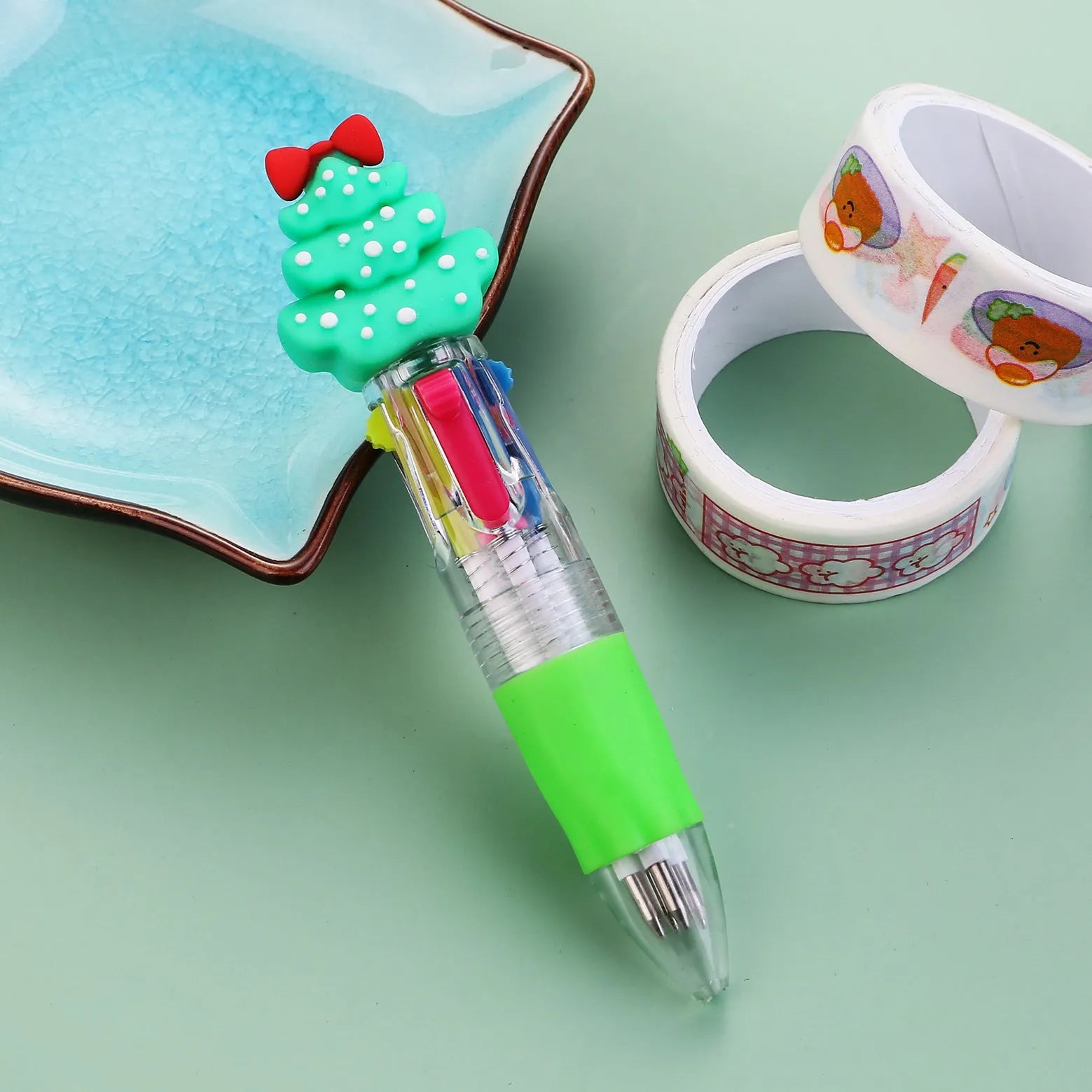 11cm long Christmas-themed four-colour ballpoint pen showing festive designs like reindeer and trees.