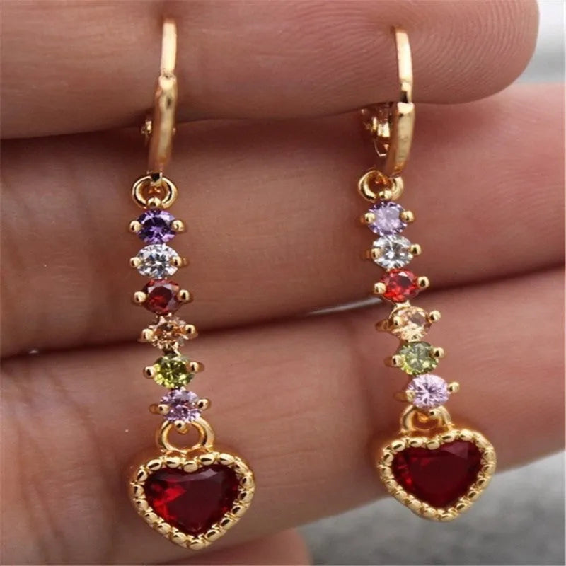 A pair of women's heart-shaped alloy earrings with a shiny electroplated gold finish.