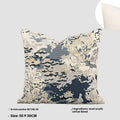 Antique blue square cushion with abstract botanical flower pattern on a grey sofa.
