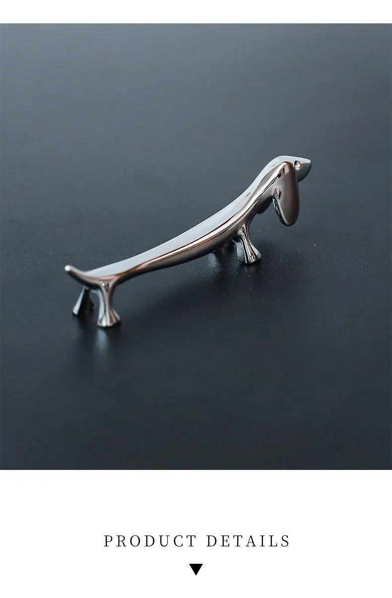 Silver zinc alloy sausage dog chopstick rest on a table