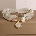 Women's crystal bracelet with gold-plated inlay, gemstones, and a Tianshan Jade ginkgo leaf pendant.