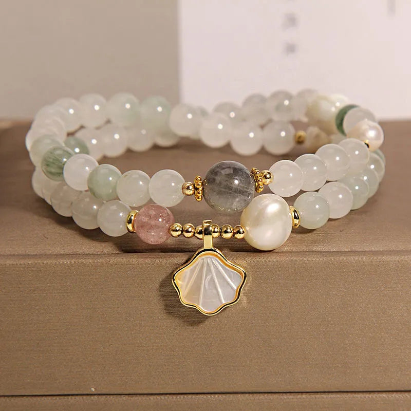 Women's crystal bracelet with gold-plated inlay, gemstones, and a Tianshan Jade ginkgo leaf pendant.