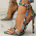 Blue women's high heels with serpentine design, hollow out details, buckle fastening, and pointed toe.