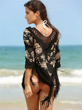 Apricot coloured V-neck sun protection shirt with hollow-out sleeves on a hanger.