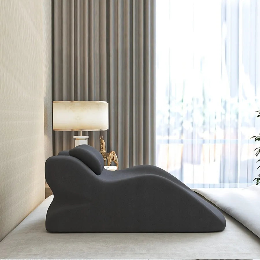 A stomach sleeping pillow shown in one of four colour options: blue, dark grey, green, or light grey.