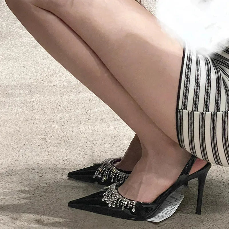 Black women's slingback high heel sandals with pointed toe, 10cm heel, and French tassel rhinestone detail.