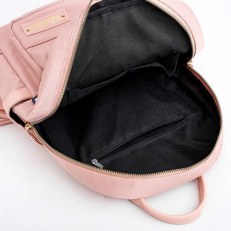 Women's black casual nylon backpack with double shoulder straps showing interior organisation compartments