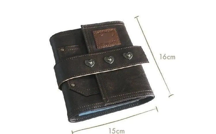 Brown A7 size notebook with a retro leather-look PU cover and metal buckle closure, lying open on a desk.