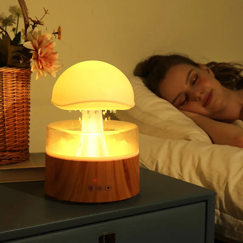 White rain cloud-shaped humidifier and essential oil diffuser on a surface