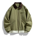 Man wearing a mint green loose-fit retro workwear jacket with contrast lapels and side seam pockets.
