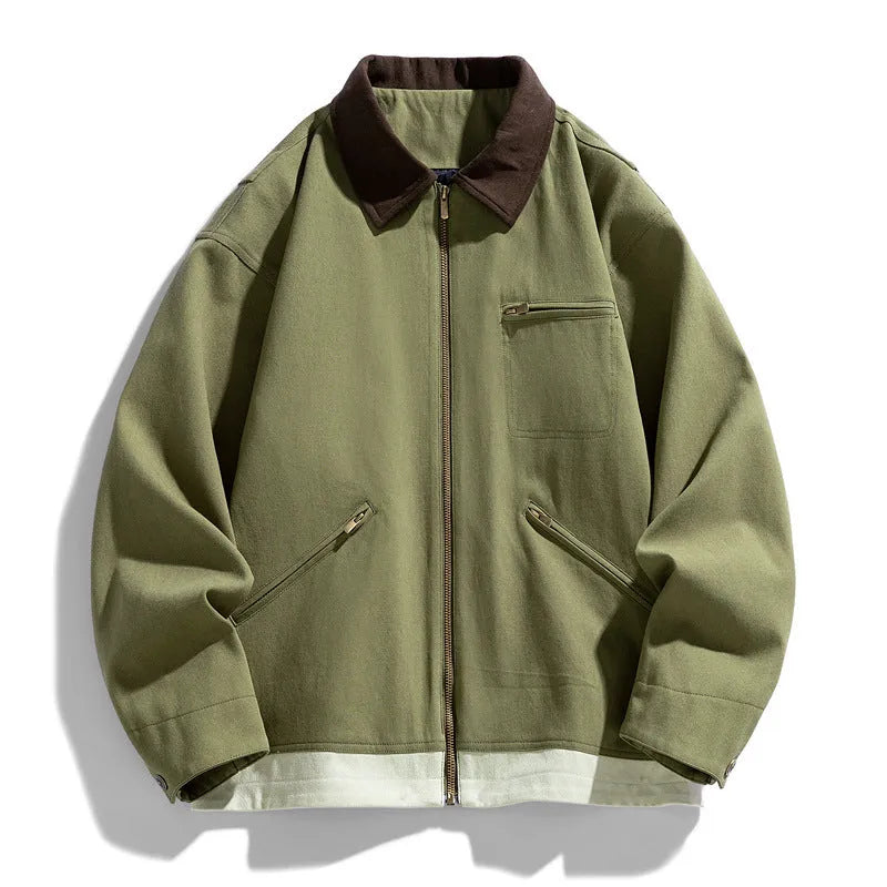 Man wearing a mint green loose-fit retro workwear jacket with contrast lapels and side seam pockets.