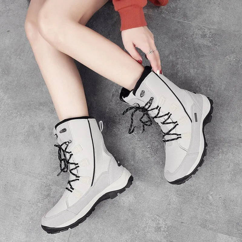 Women's black genuine leather mid-calf thermal snow boots with a round toe and rubber sole.