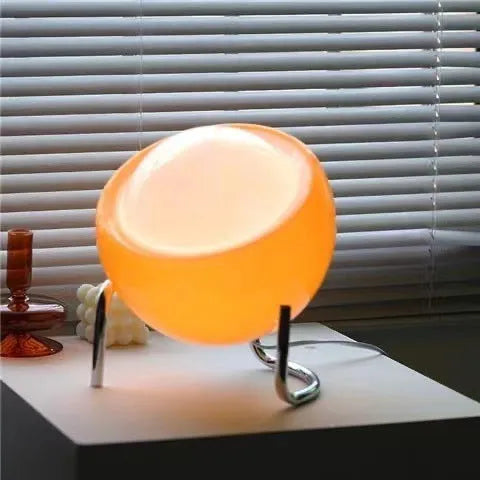 Medieval cream style USB table lamp with glass shade and tricolor light options on a bedside table