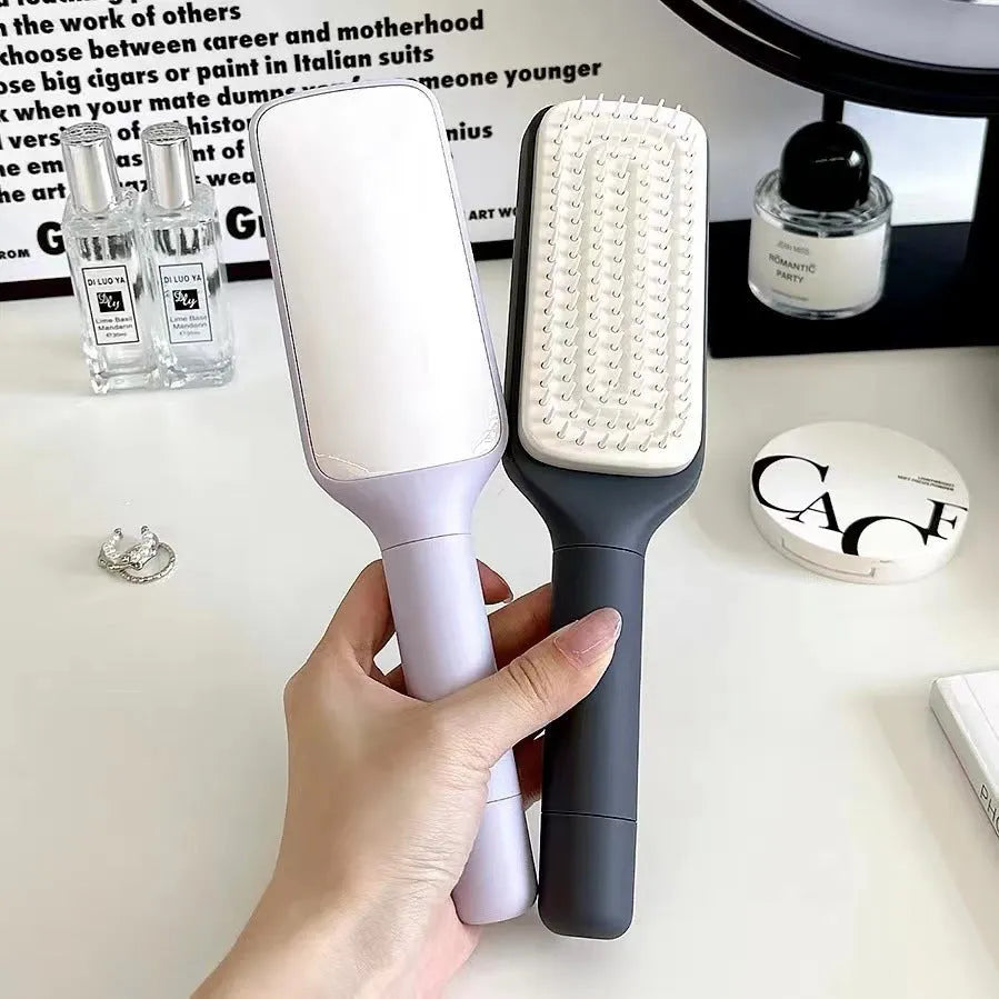 Roland purple self-cleaning hair brush with rotating handle for easy hair removal.