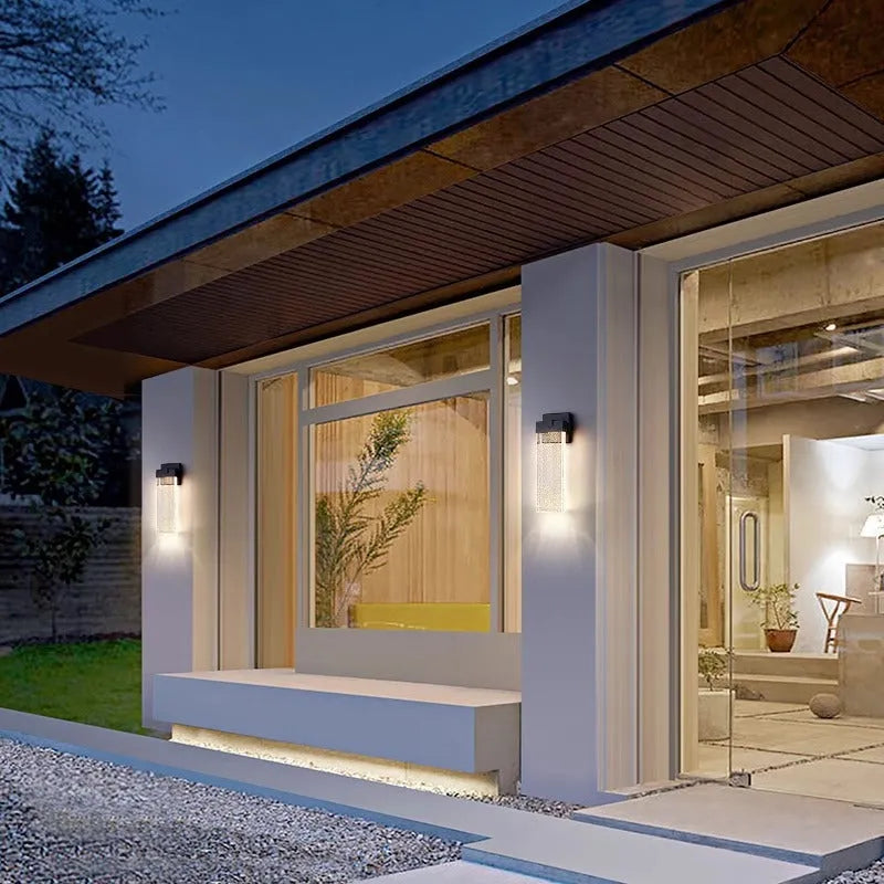 Black outdoor LED wall lamp in stainless steel with warm light for courtyards and corridors