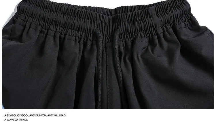 Men's black quick-drying training shorts with elastic waistband and above-knee length