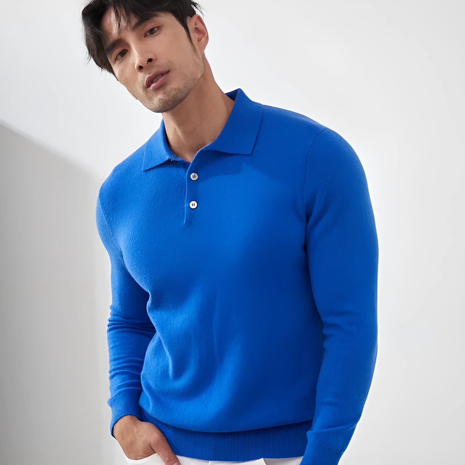 Man wearing a sapphire blue cashmere polo collar pullover sweater with a loose fit
