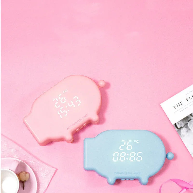 Blue and pink multifunctional LED digital alarm clock displaying time and temperature, with USB charging cable