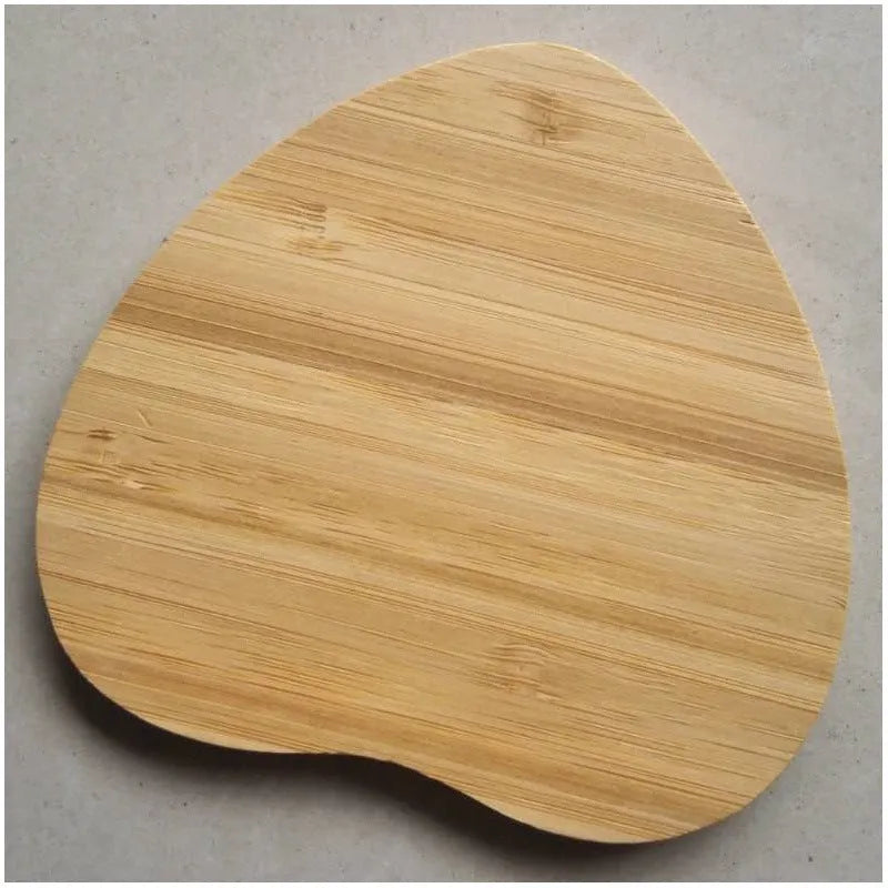 Square wooden bamboo 5W QI wireless charging pad for smartphones on a desk.
