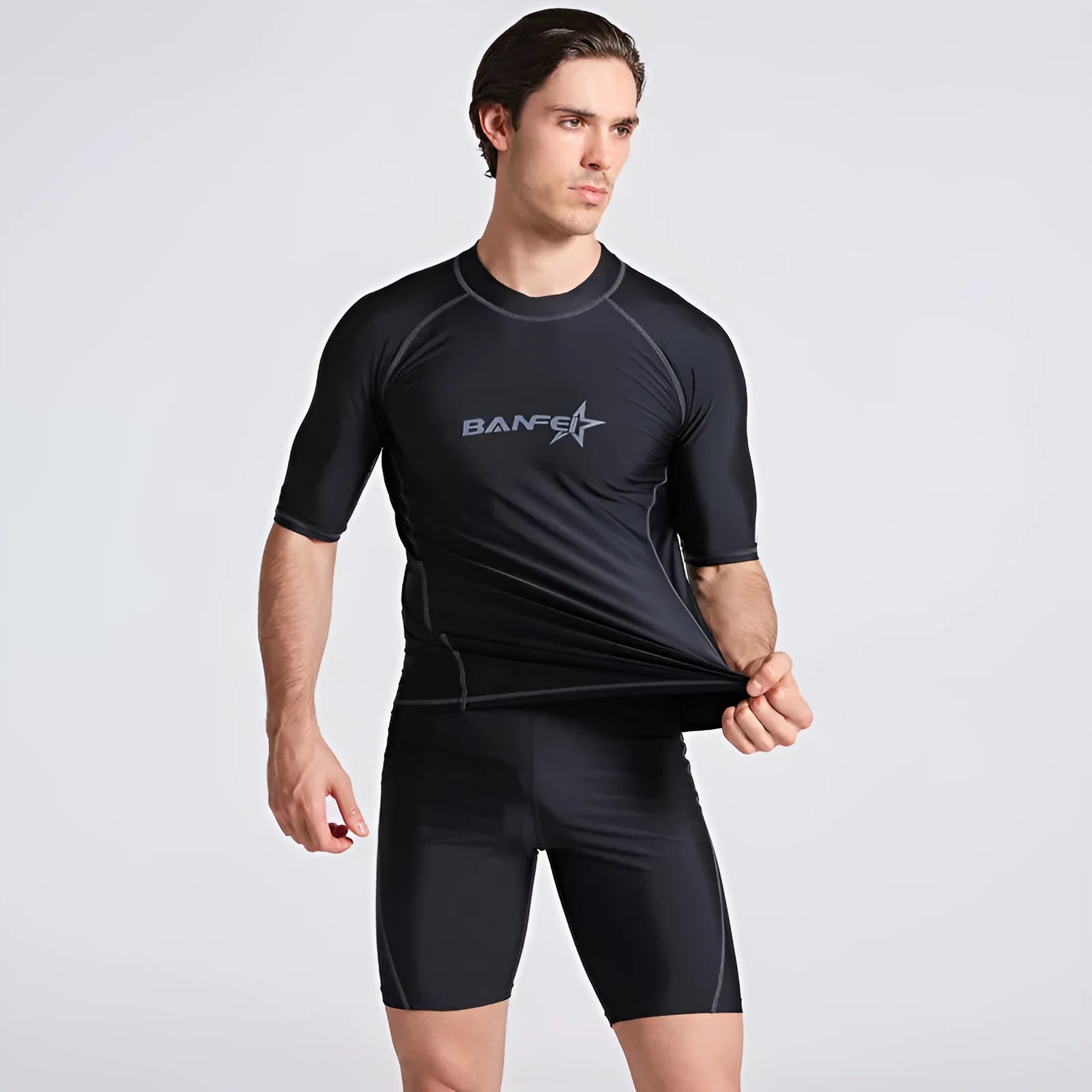 Men's quick-drying half sleeve swim top and pant set in nylon fabric on a white background.