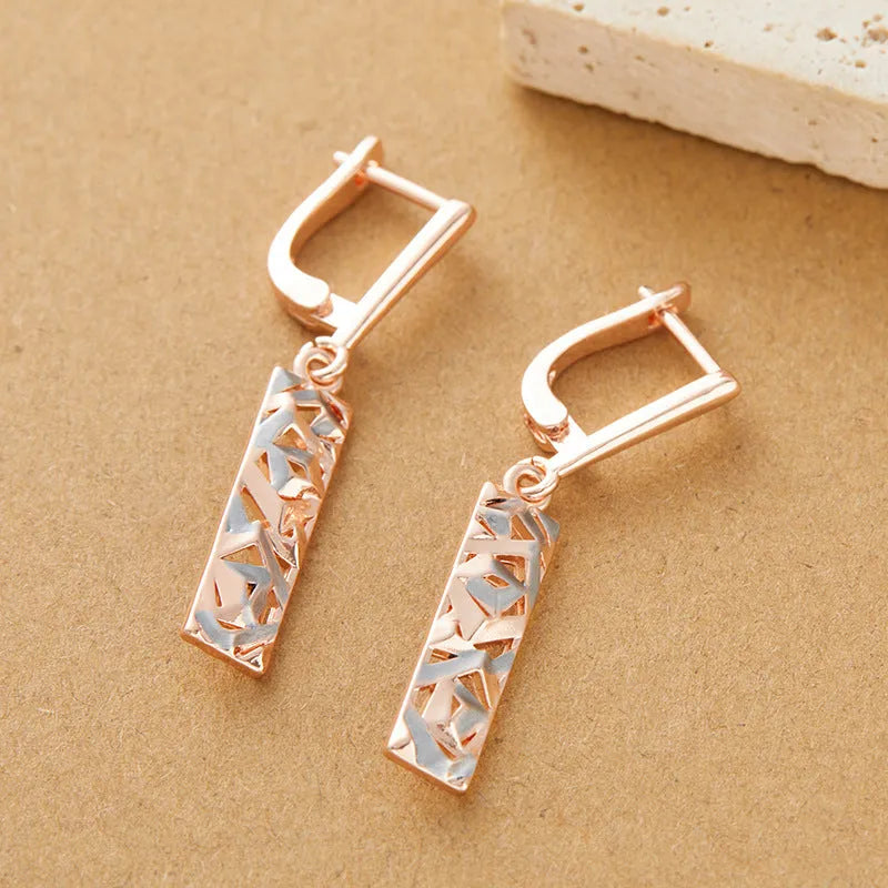 A pair of rectangular two-tone hollow stud earrings with a geometric design and electroplated alloy finish.