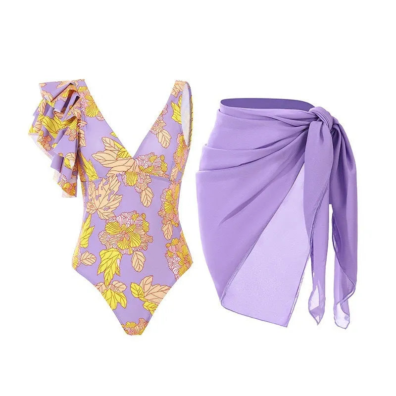 Women's solid colour one-piece swimsuit with spaghetti straps and a matching skirt laid flat.