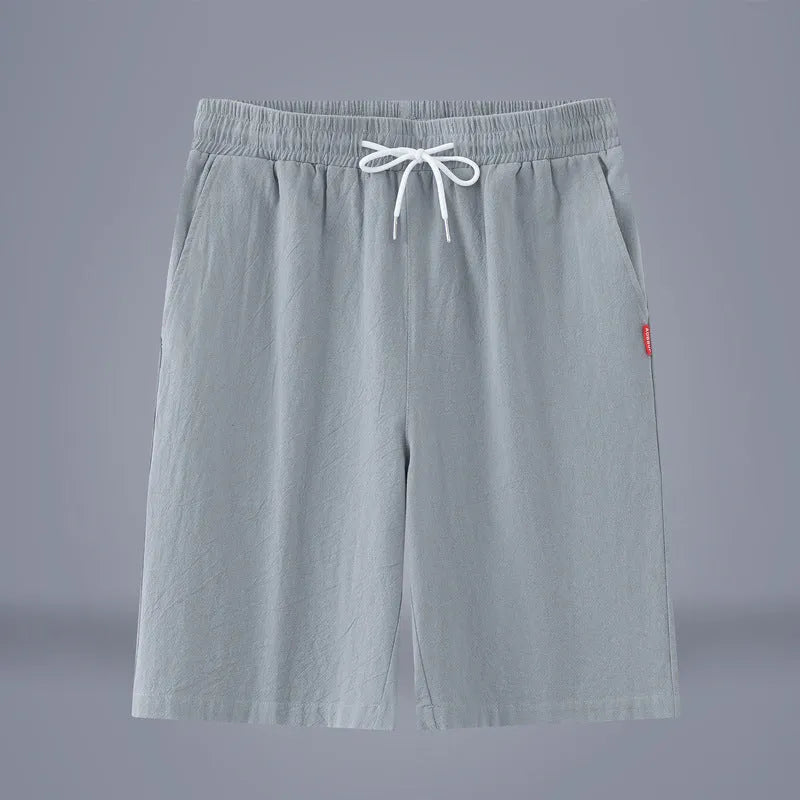 A pair of solid colour cotton linen cropped pants with a drawstring waist, shown in Army Green.