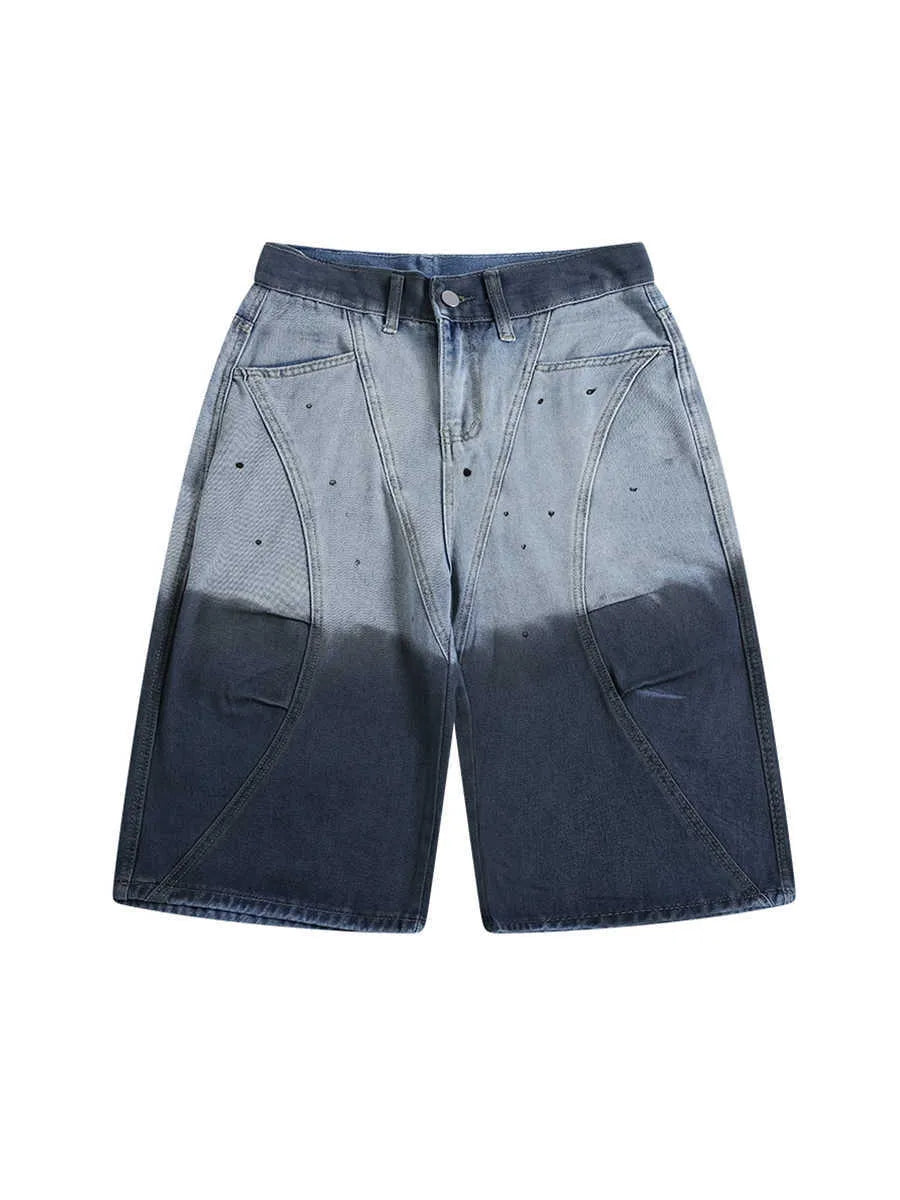 Loose fit blue tie-dye gradient cropped jeans on a hanger, showing washed-out colour and mid-waist design.