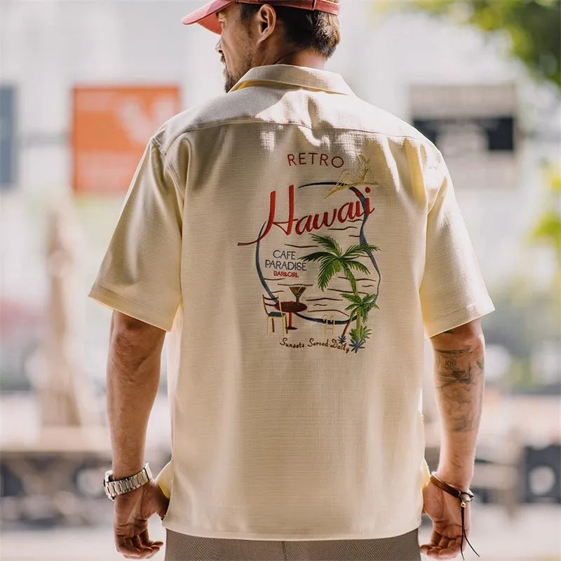Light apricot men's shirt with bamboo floral pattern and Cuban collar on hanger