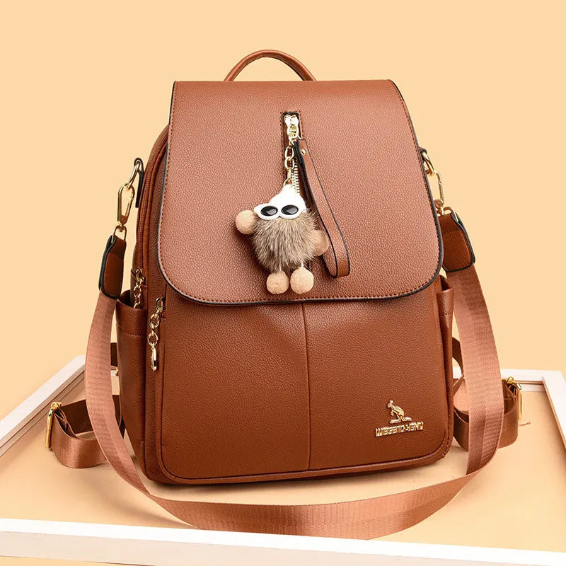 Genuine leather women's student travel backpack with pendant in beige colour, featuring covered outer pocket and belt decoration