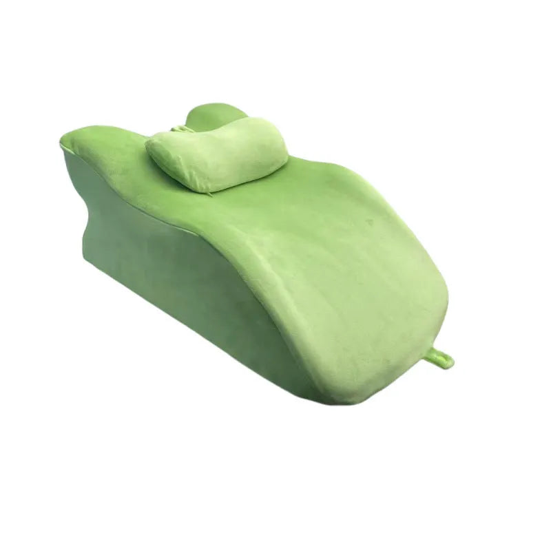 A stomach sleeping pillow shown in one of four colour options: blue, dark grey, green, or light grey.